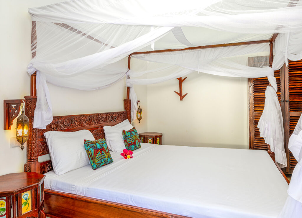 Comfortable bed in a cozy room at Tasneem Hotel, Jambiani, Zanzibar - ideal for a restful sleep