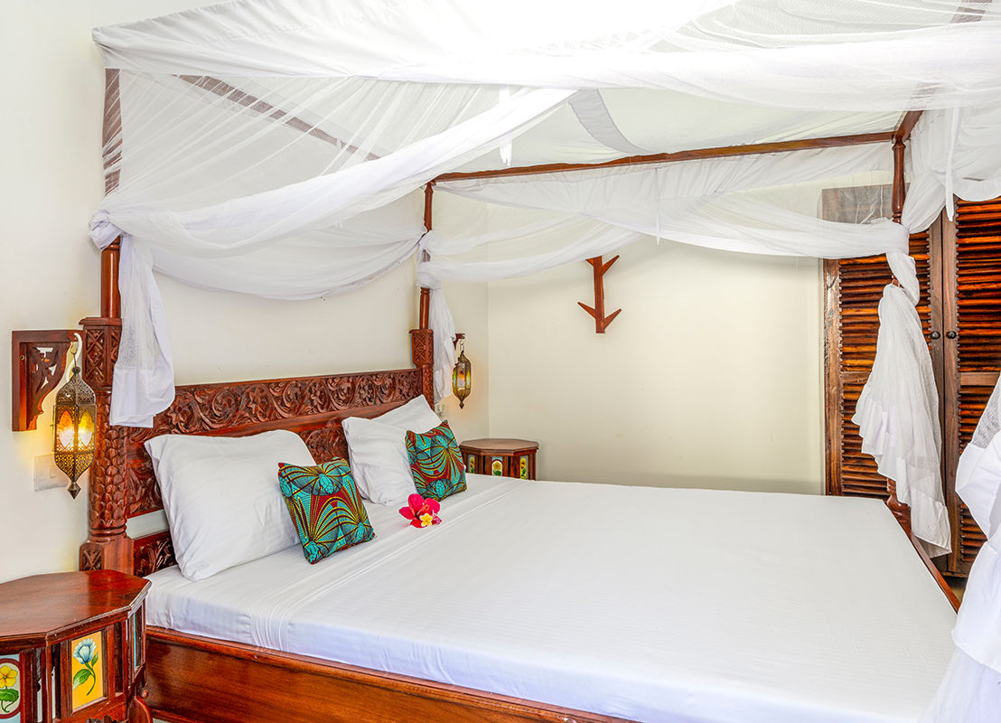Comfortable bed in a cozy room at Tasneem Hotel, Jambiani, Zanzibar - ideal for a restful sleep