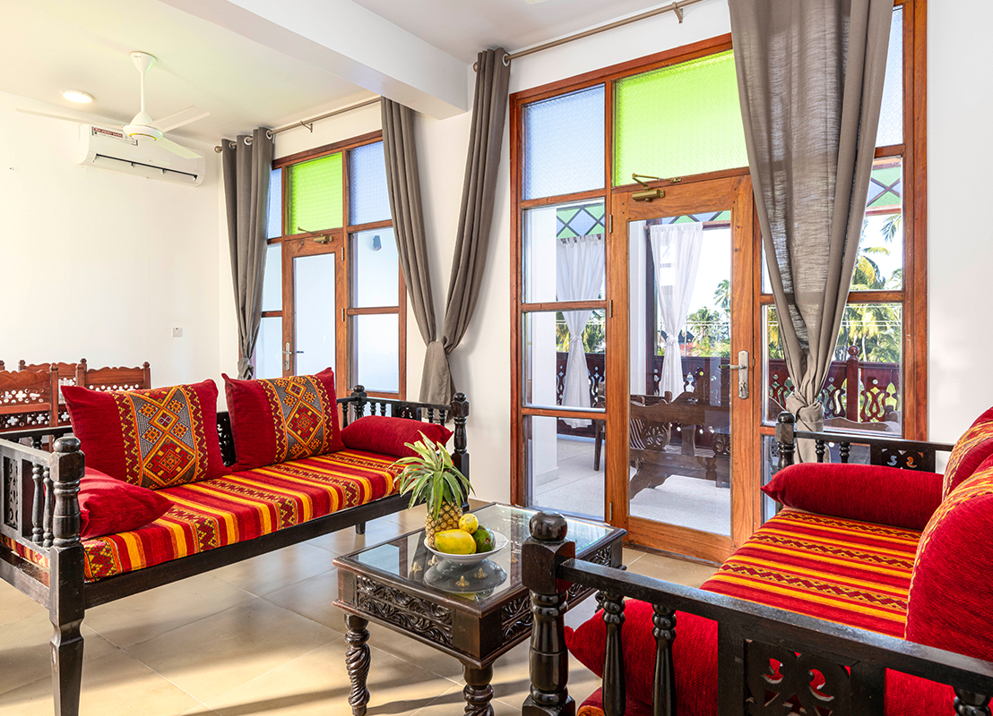 Cozy sitting area in the lobby of Tasneem Hotel, Jambiani, Zanzibar with traditional furniture and tropical view