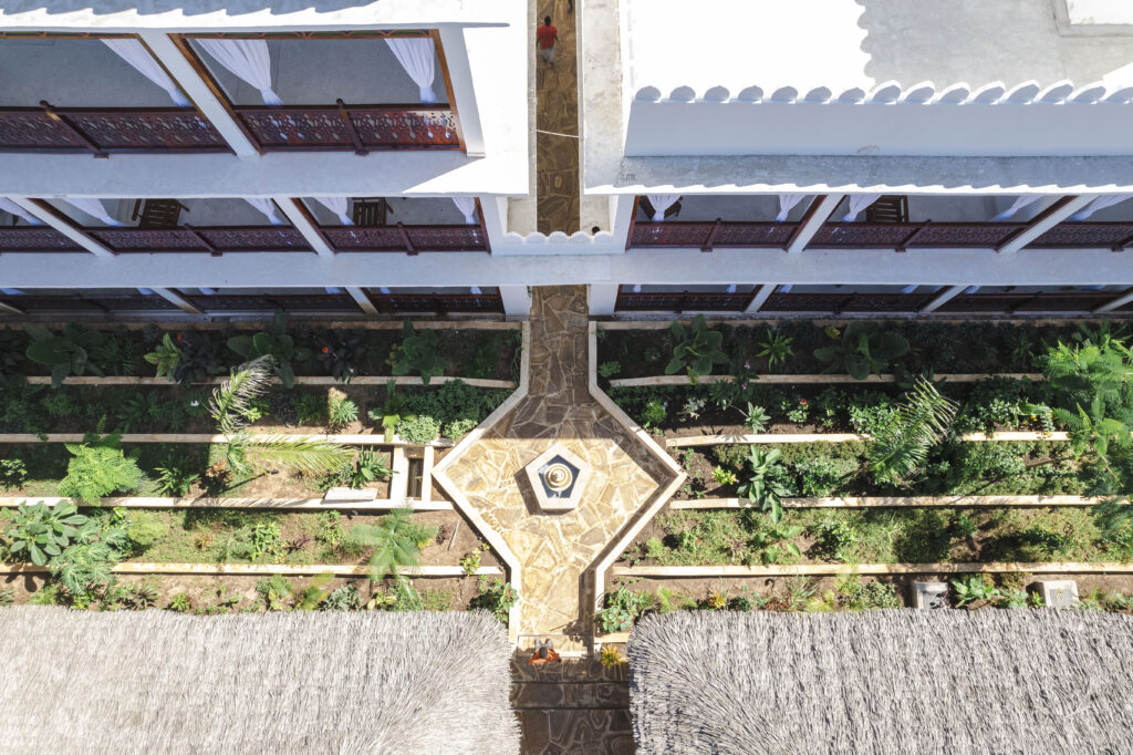 Beautiful garden courtyard with a fountain and balconies at Tasneem Hotel, Jambiani, Zanzibar
