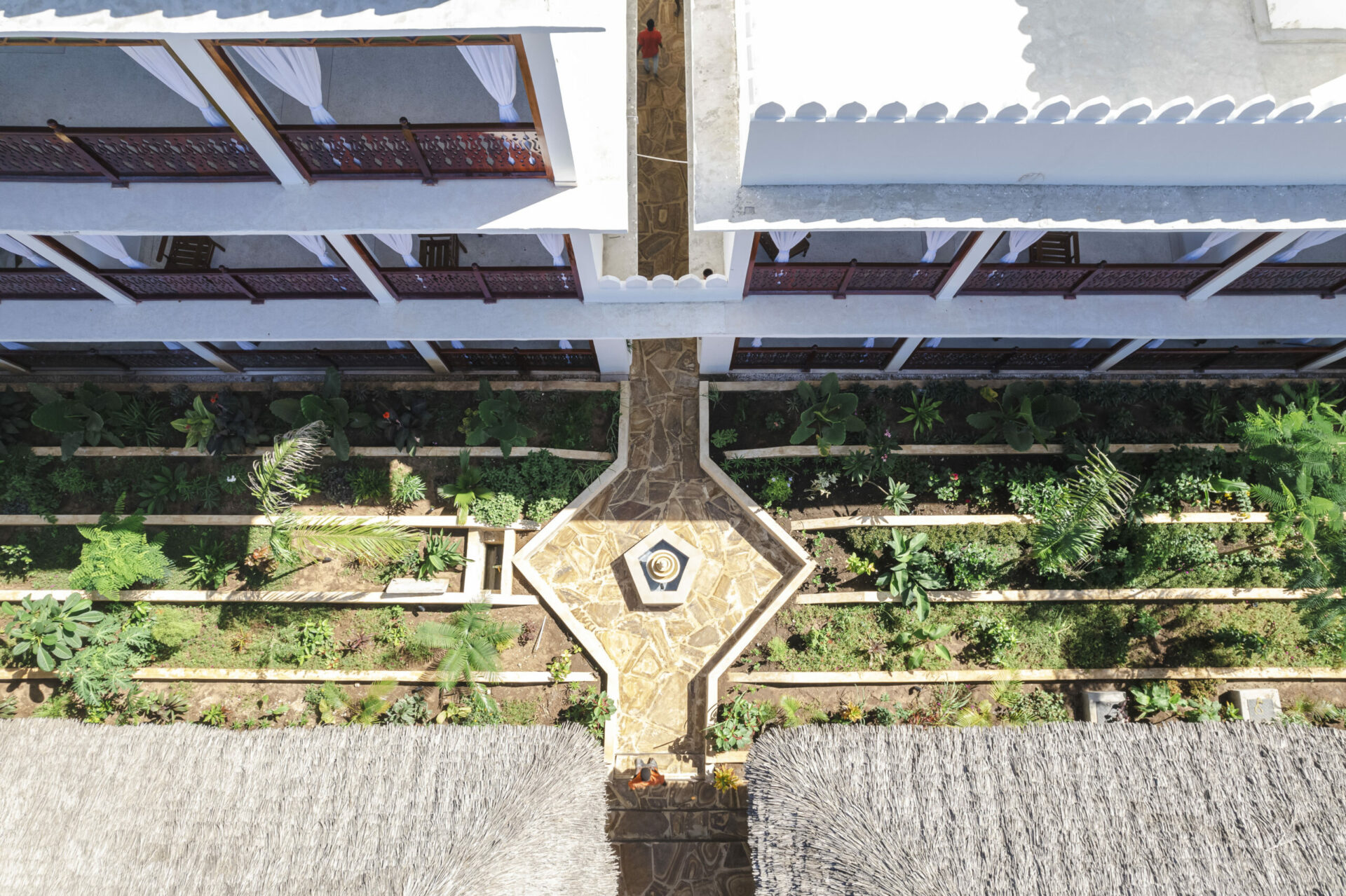 Beautiful garden courtyard with a fountain and balconies at Tasneem Hotel, Jambiani, Zanzibar