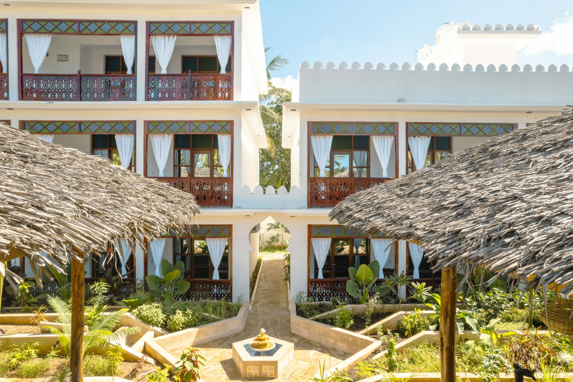 Beautiful garden courtyard with a fountain and balconies at Tasneem Hotel, Jambiani, Zanzibar