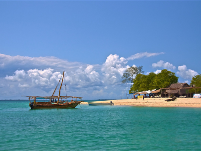 City tour guide service by Tasneem Hotel Zanzibar, exploring Jambiani's beach with traditional boats