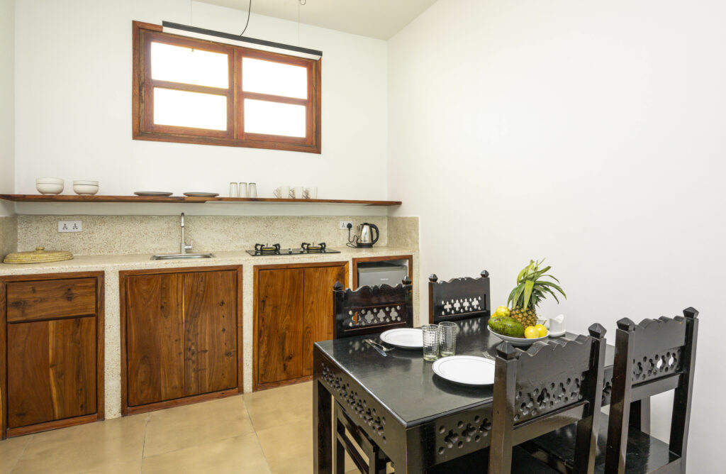 Kitchen with modern dining area at Tasneem Hotel Zanzibar, providing a cozy and functional space for guests