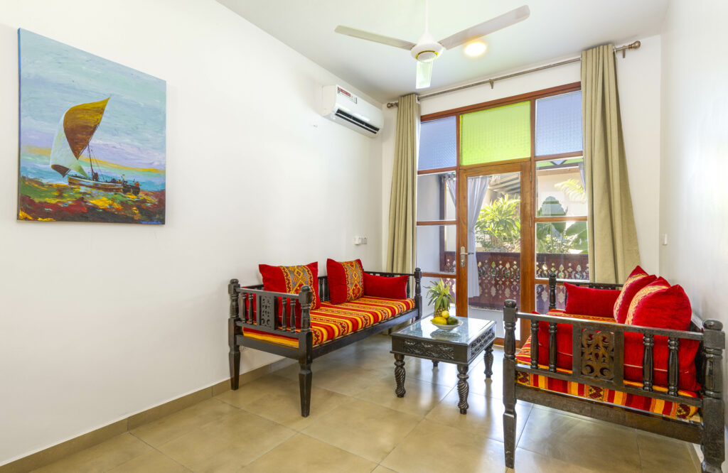 Cozy sitting area in the lobby of Tasneem Hotel, Jambiani, Zanzibar with traditional furniture and tropical view