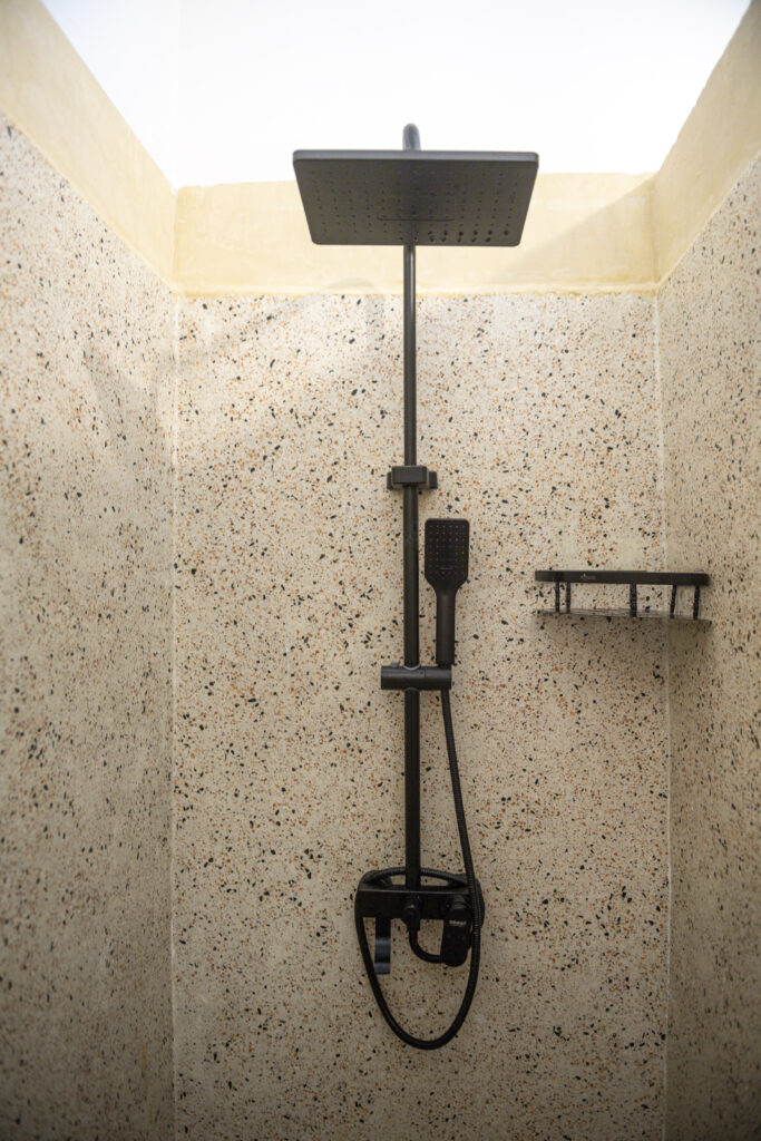 Simple and clean shower area at Tasneem Hotel Zanzibar, designed for comfort and practicality