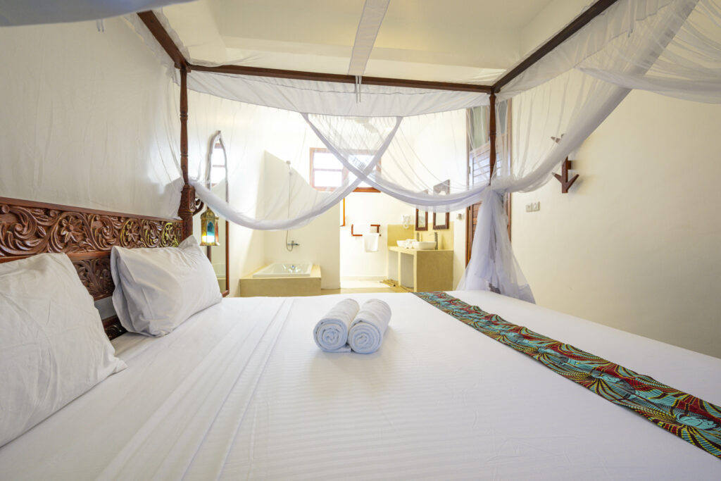 Comfortable bed in a cozy room at Tasneem Hotel, Jambiani, Zanzibar - ideal for a restful sleep