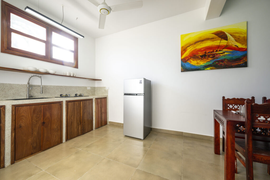 Kitchen with modern dining area at Tasneem Hotel Zanzibar, providing a cozy and functional space for guests